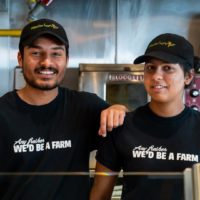 employees smiling at mucho burrito franchise