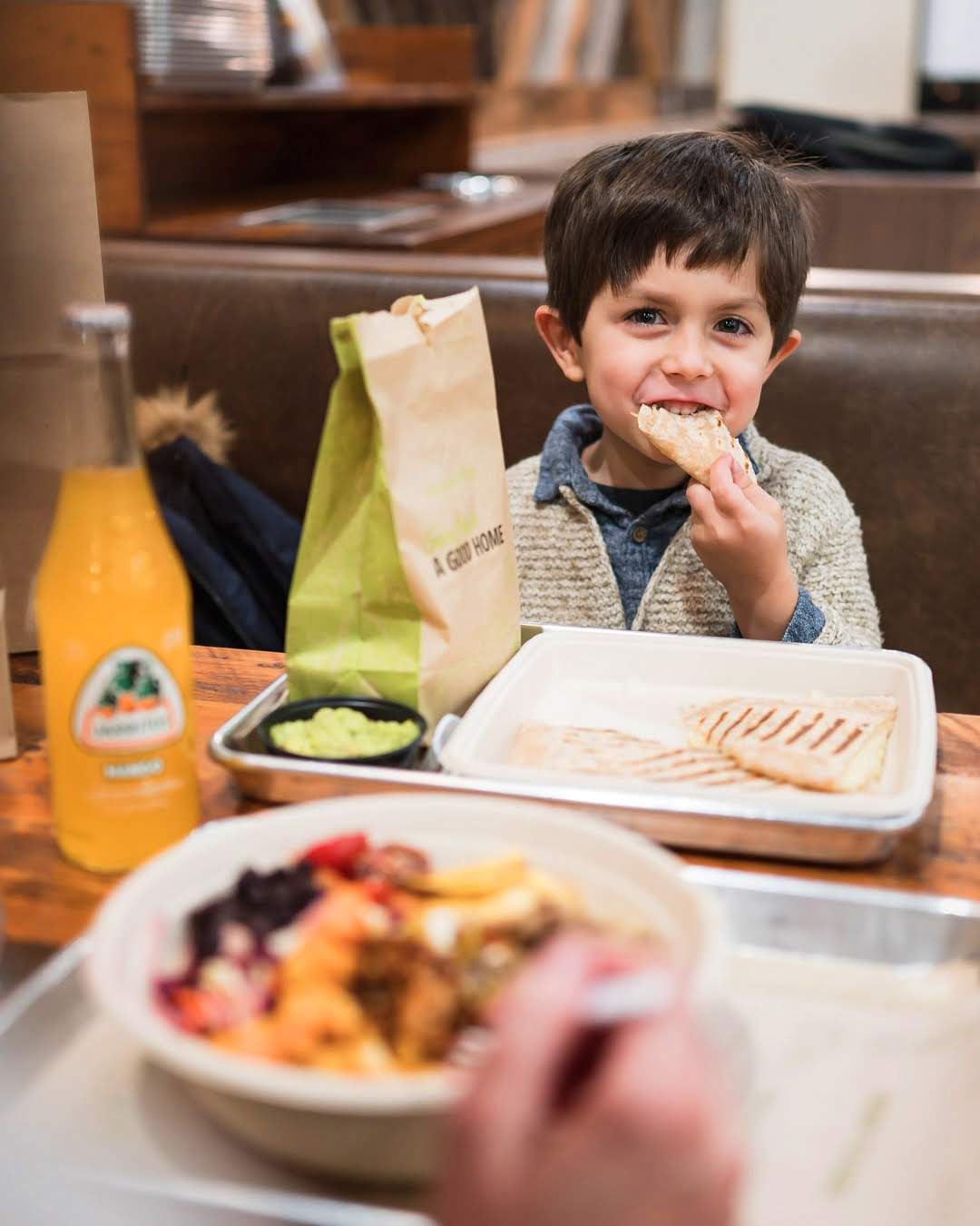 child enjoys meal from mucho burrito franchise