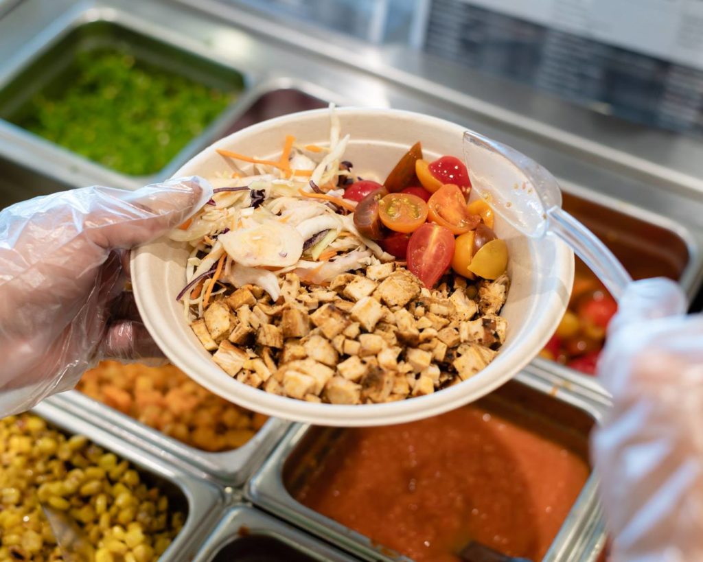 preparation of a food plate from mucho burrito mexican cuisine franchise
