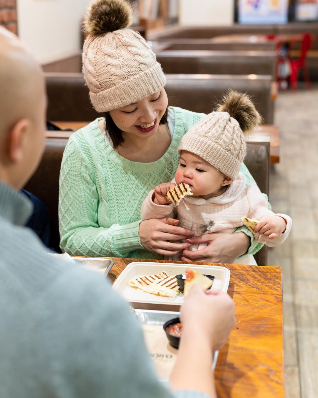 baby eats quesadilla from mucho burrito franchise